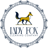 Decorative circular border in navy blue. Drawing of an elegant fox in dark blue, burnt yellow, and white is strutting confidently. Underneath fox it reads, "Lady Fox Cleaning Company"